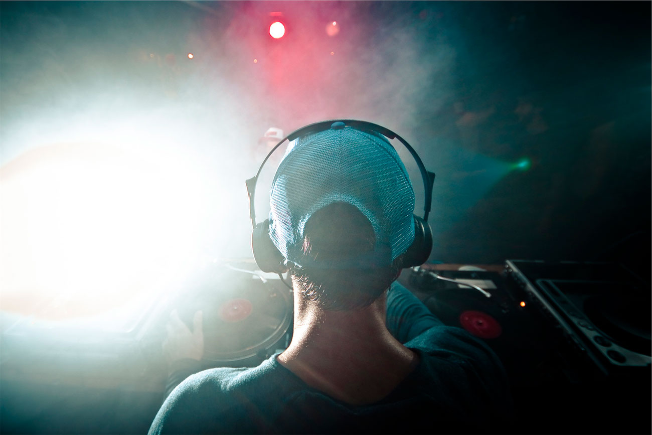 back of women's head waring a ballcap and headphones.
