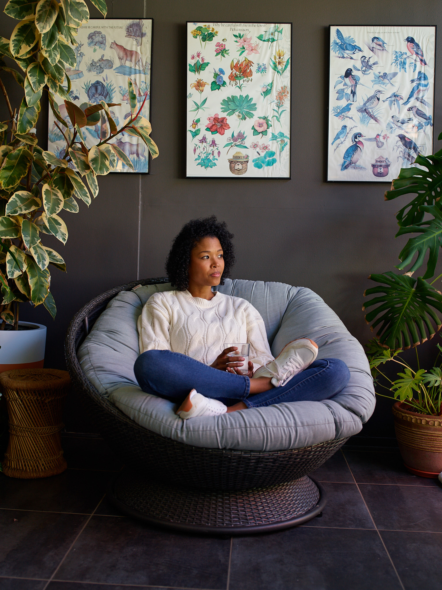 Woman seated in a papasan chair