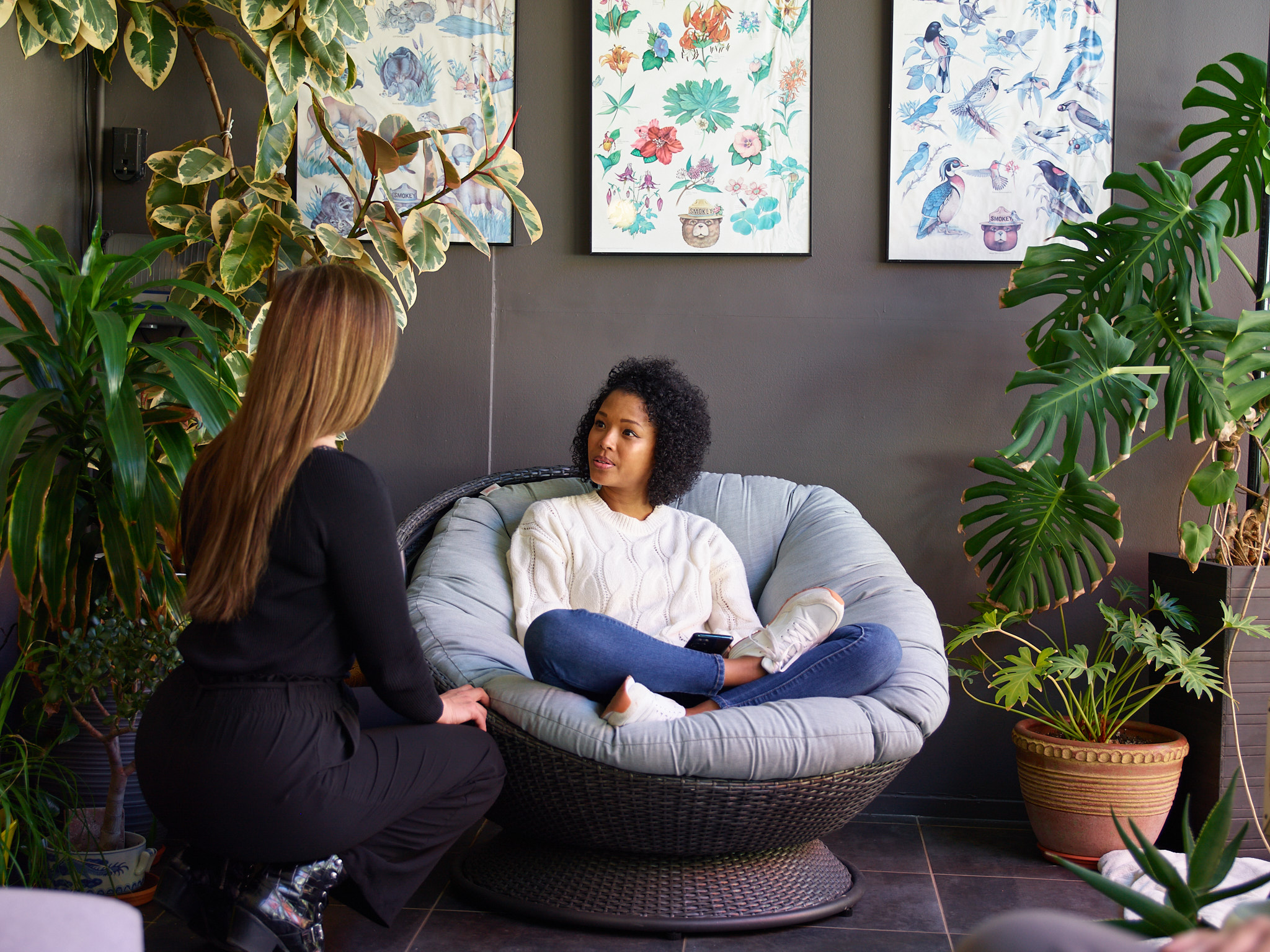 Woman seated on a papasan chair