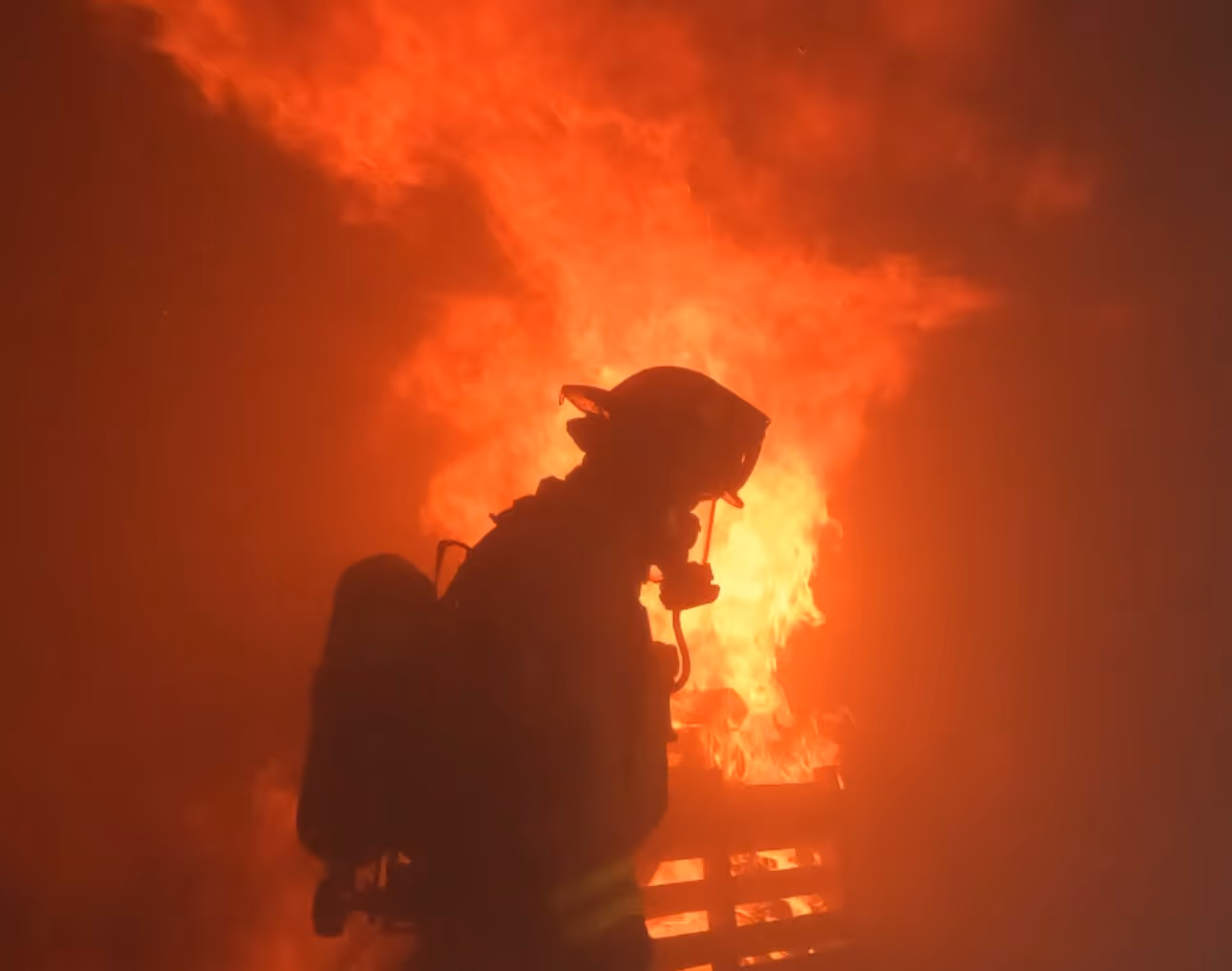 Firefighter silhouette in front of fire