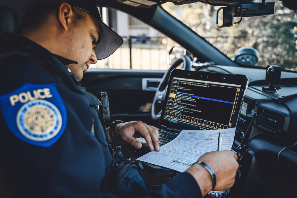 officer in the car checking the record