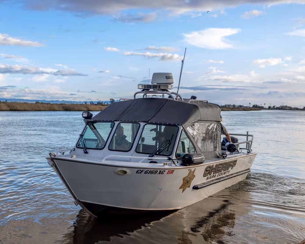 Napa County Sheriff's patrol boat on calm water under a partly cloudy sky.