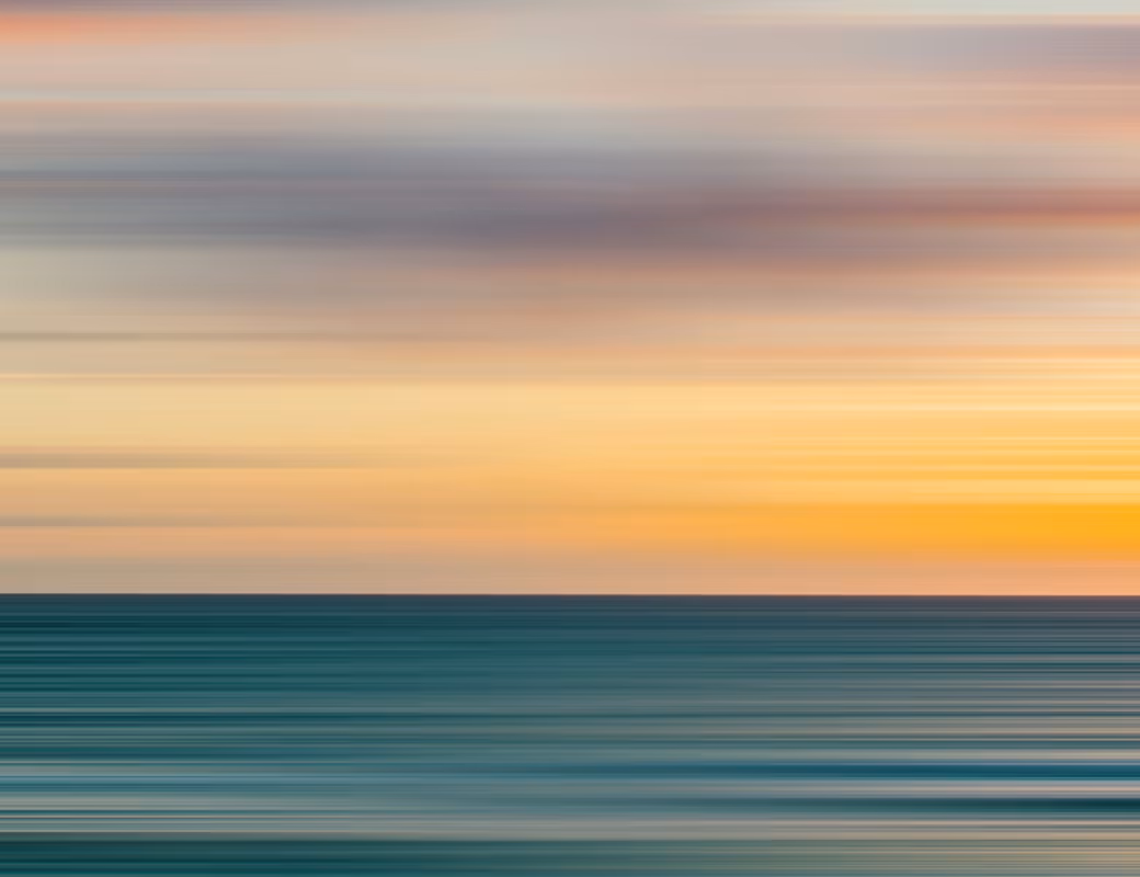 Abstract blurred seascape at sunset with horizontal motion effect.