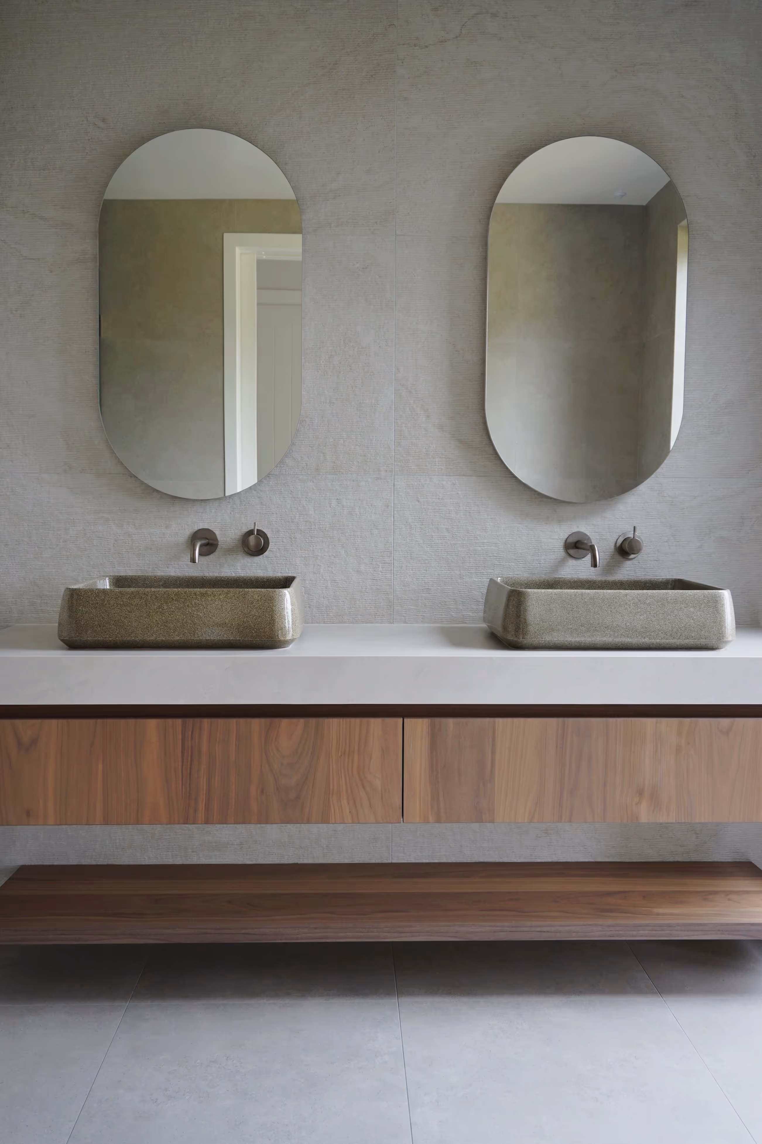 Bathroom with two sinks and two mirrors.