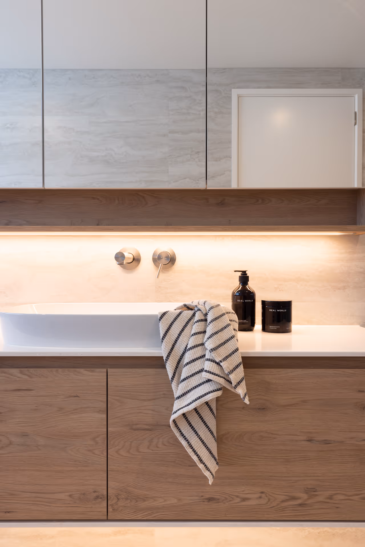 Bathroom with towel hanging on sink. 