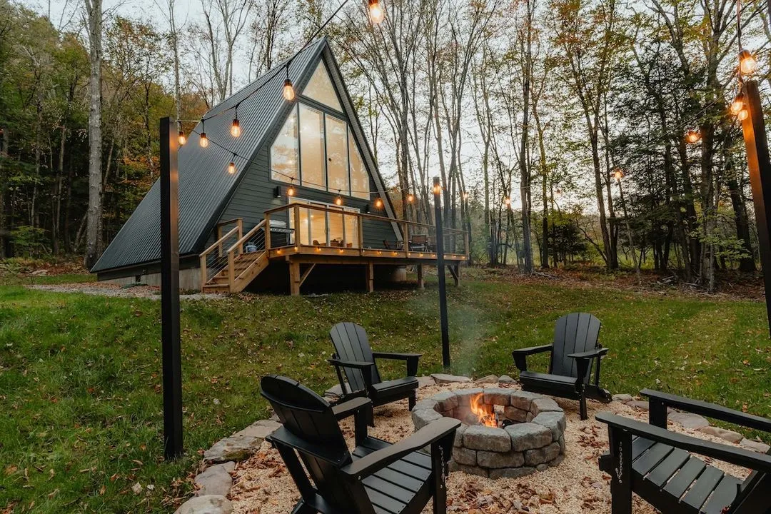 Beautiful cabin with a large yard and fire pit with chairs around