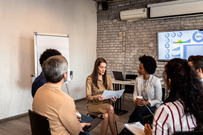 group of people in a meeting talking about hr strategy