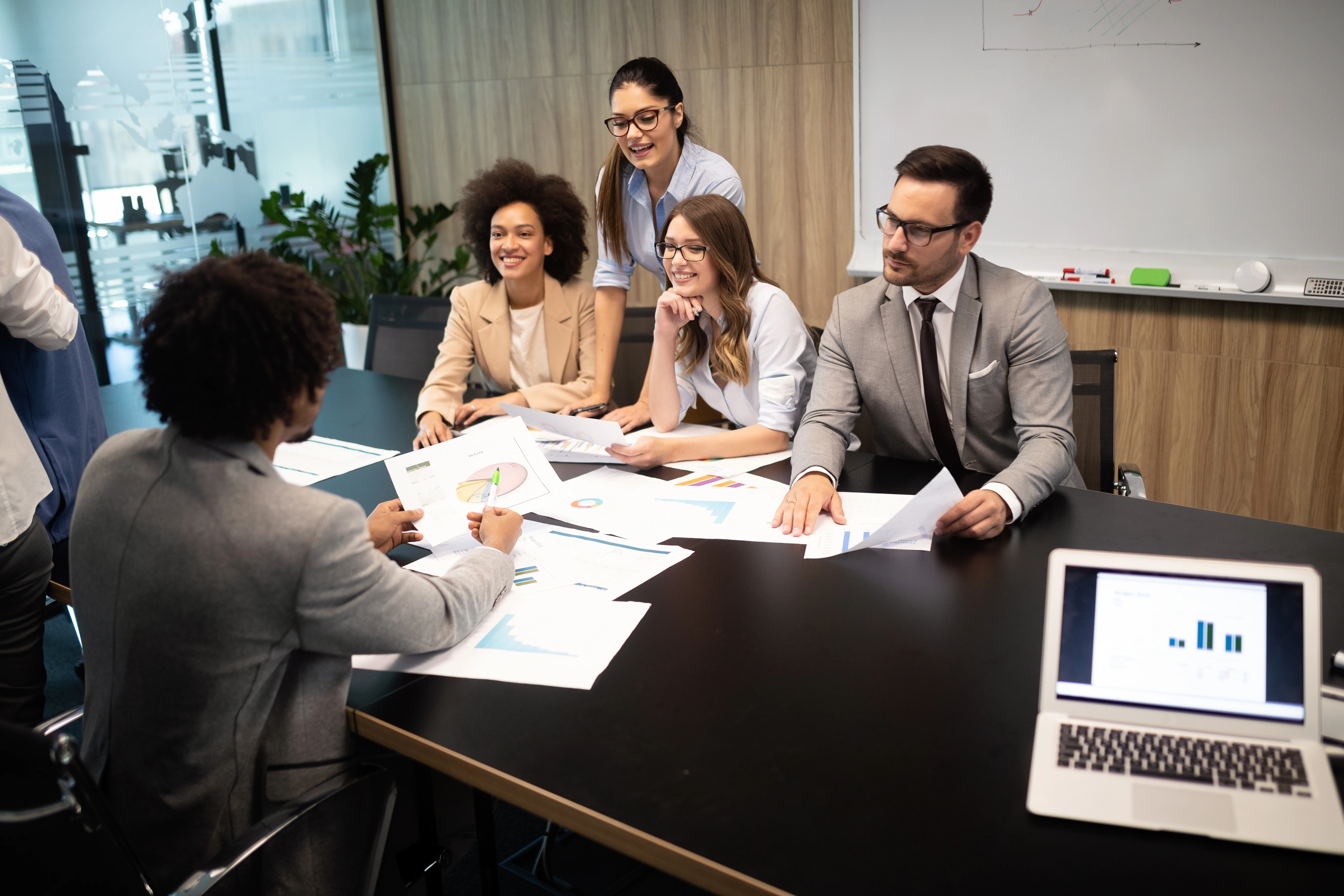 A group of HR professionals reviewing employee performance data