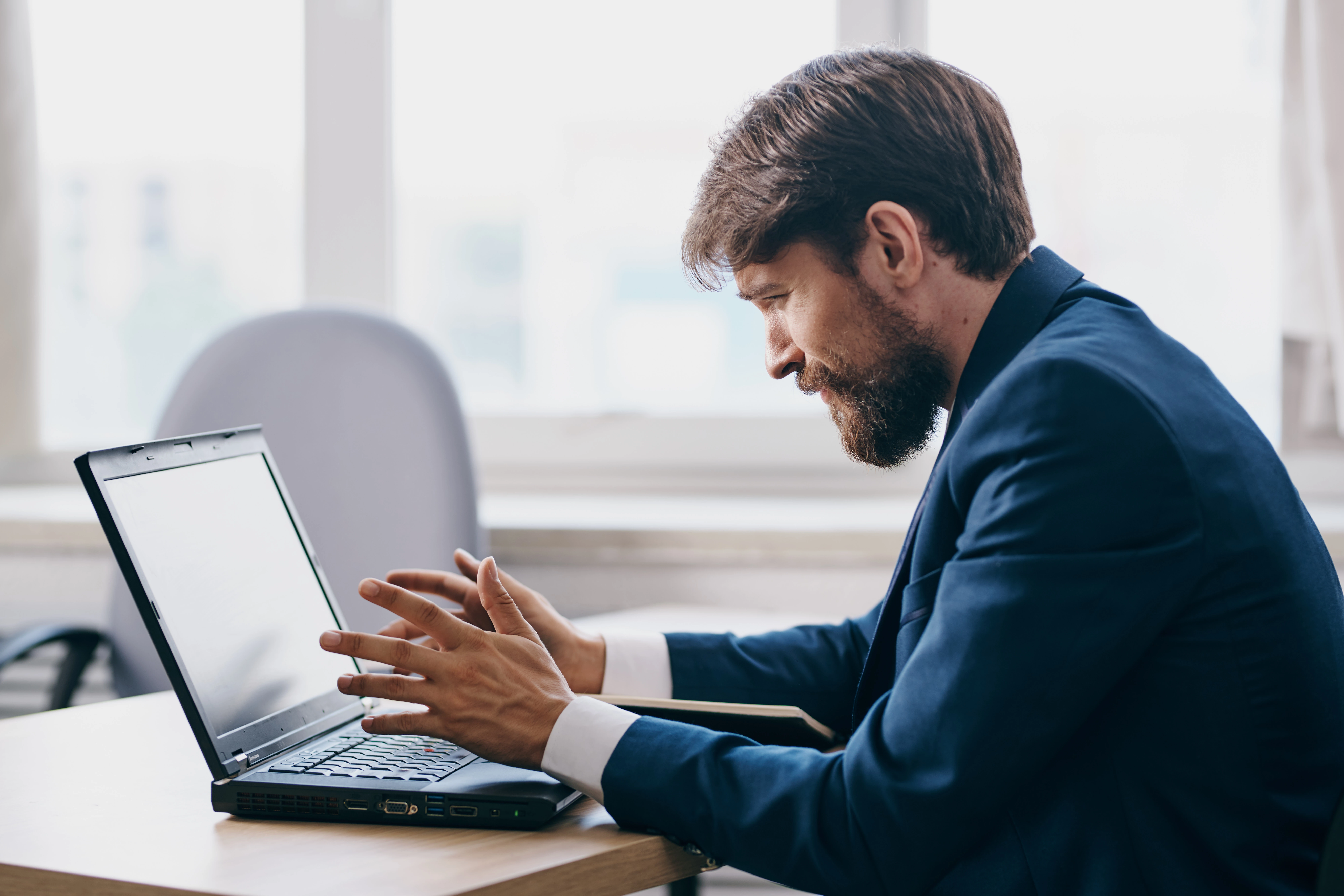HR manager analyzing employee turnover data on a laptop