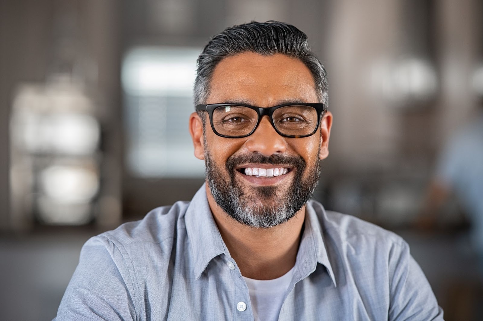Confident man smiling to illustrate results of cosmetic dental treatments and smile makeovers at Church View Dental in Essex.
