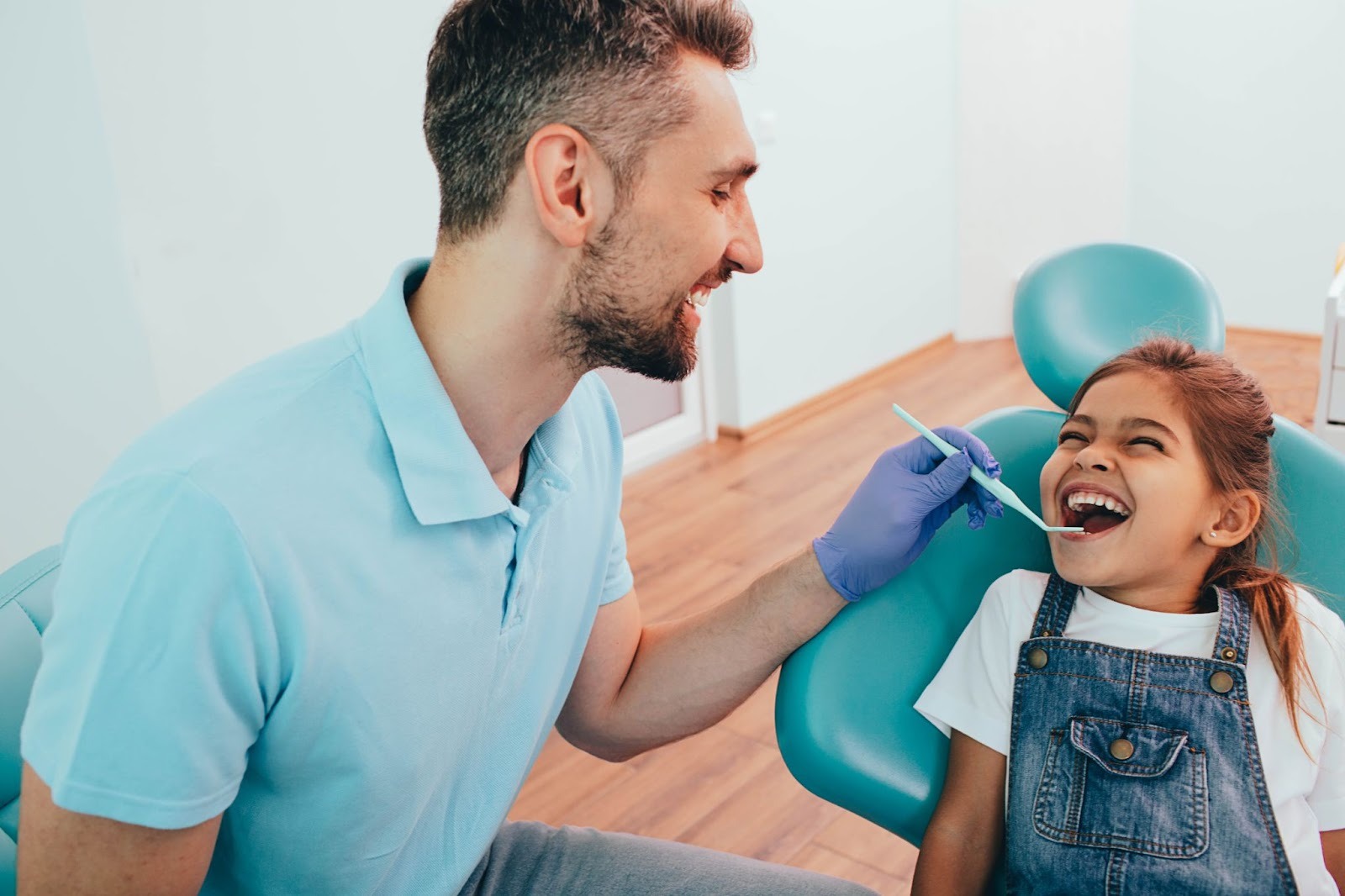 Dentist and young child smiling during a routine dental check-up at a family dental clinic in Essex.