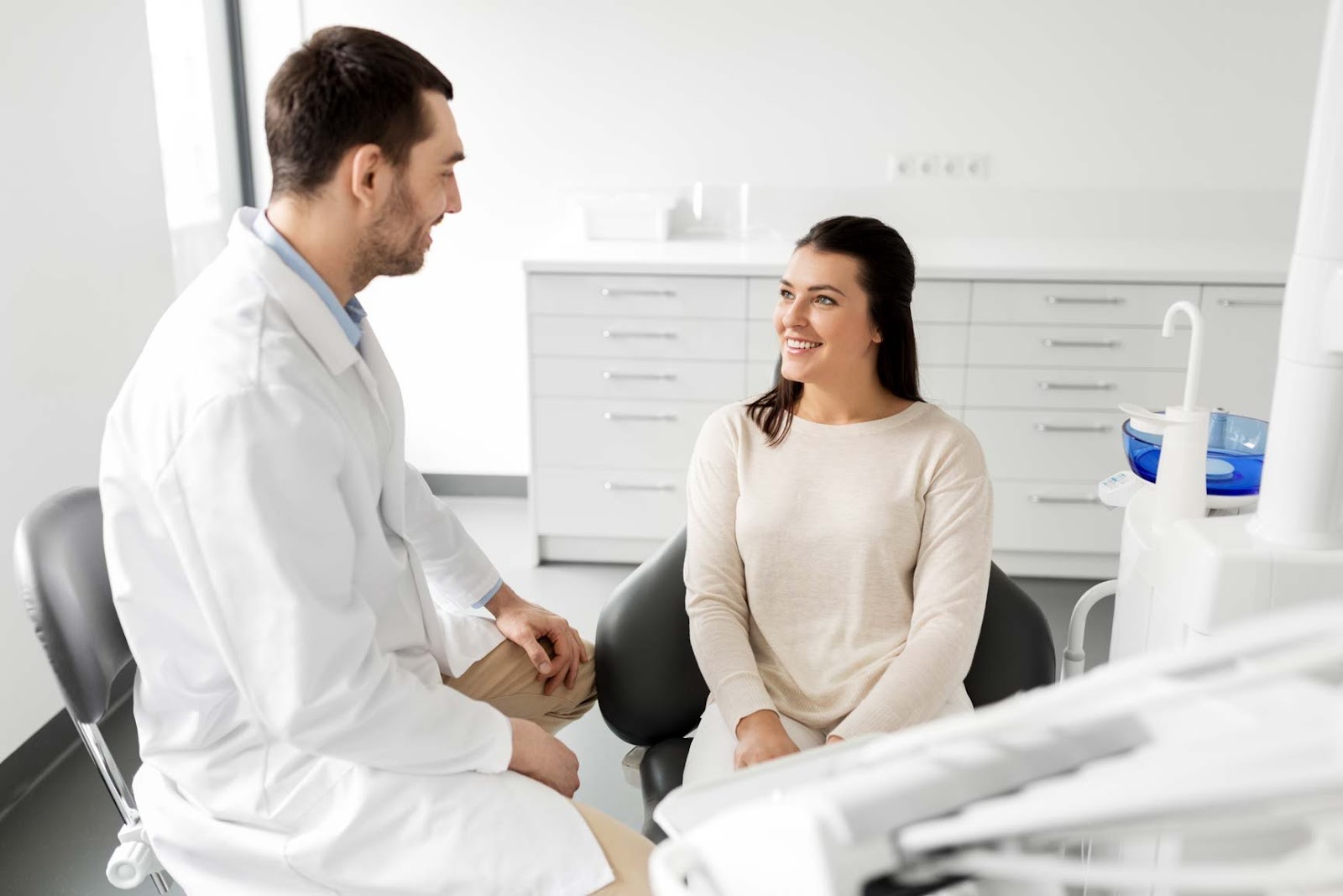 Dentist discussing oral health and treatment options with a patient during a routine dental consultation in Upminster dental practice