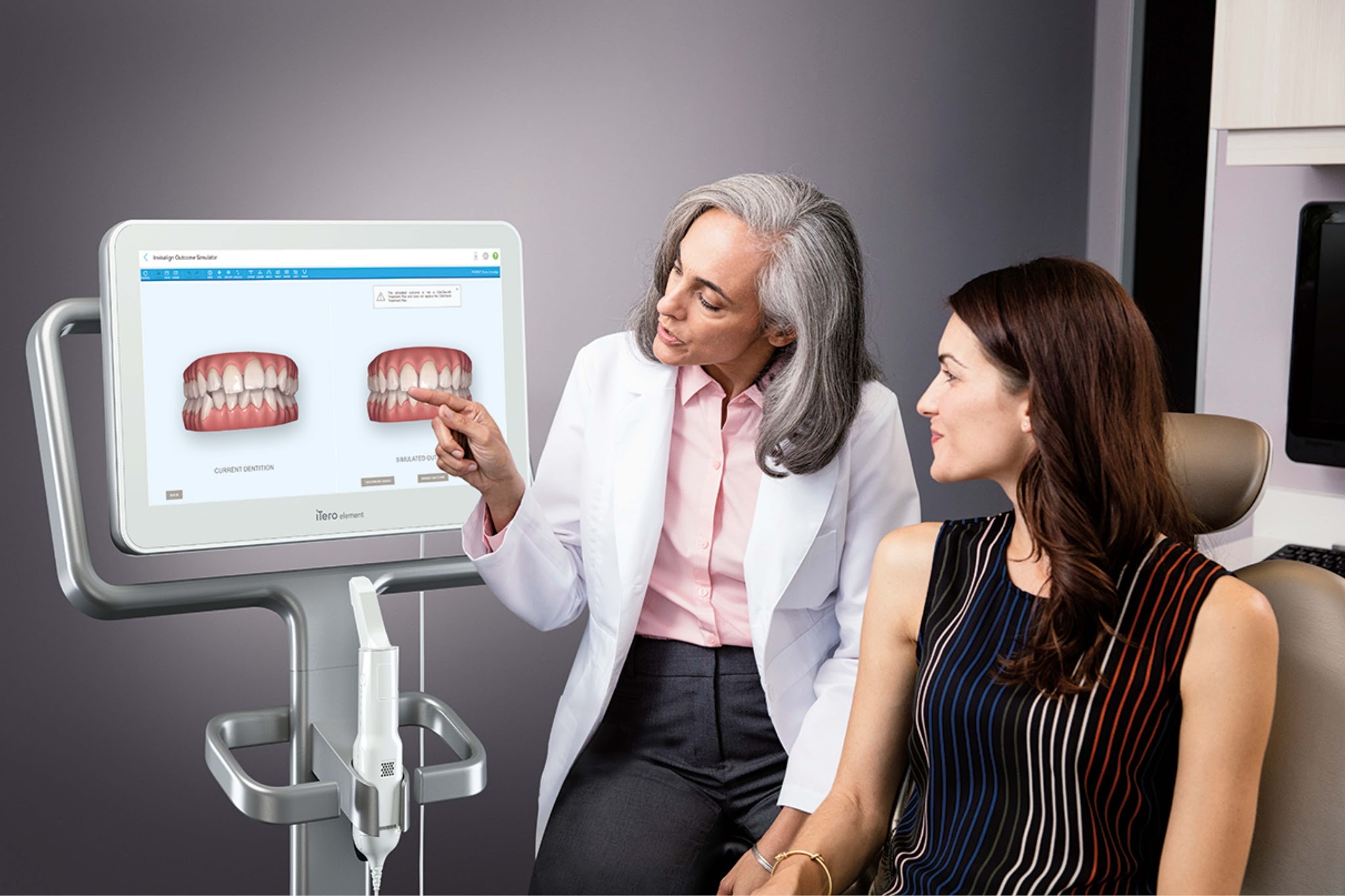 Dentist explaining Invisalign treatment plan and results during consultation in Upminster