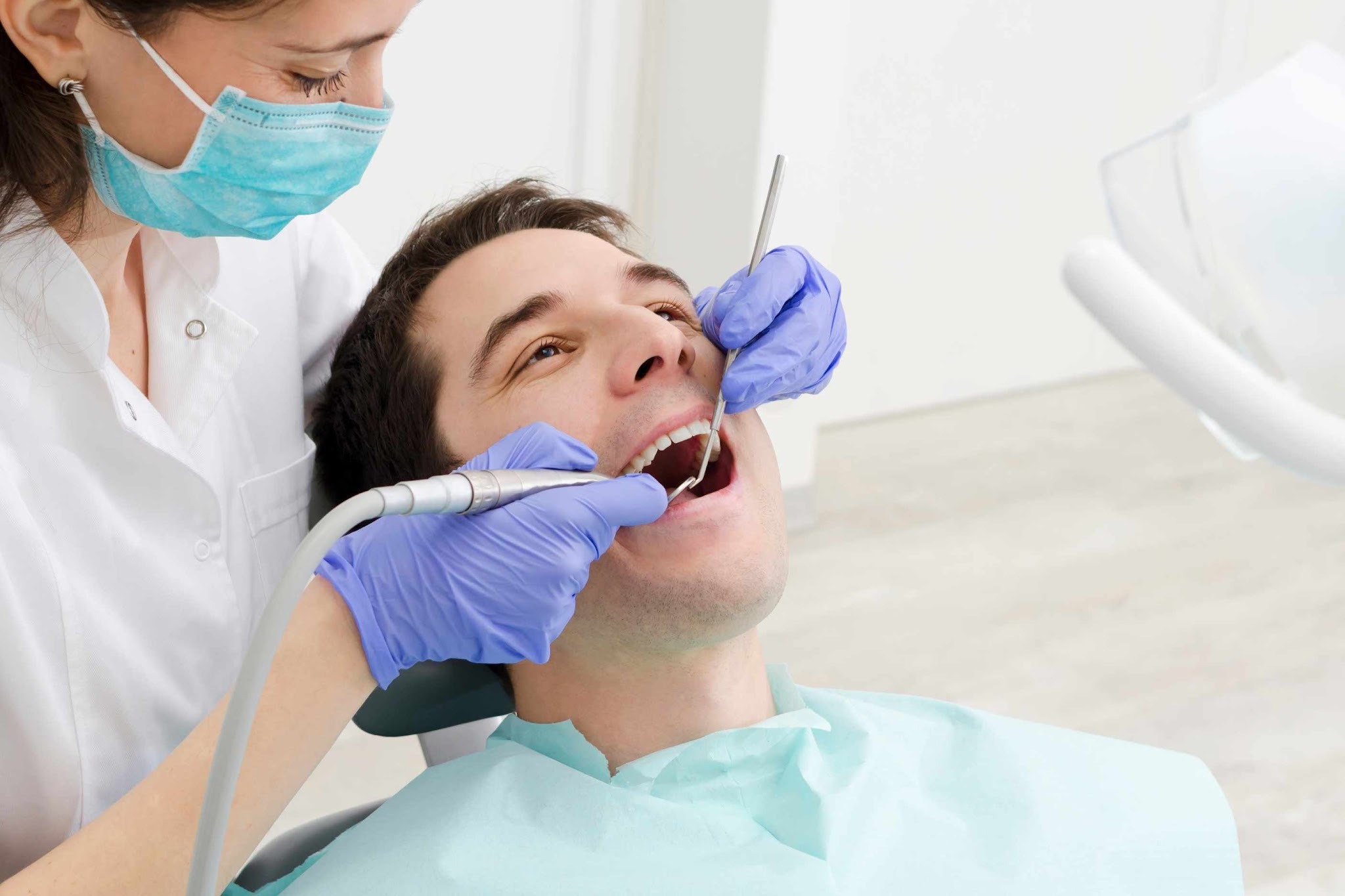 Dentist carrying out gum health assessment and periodontal examination for gum disease treatment