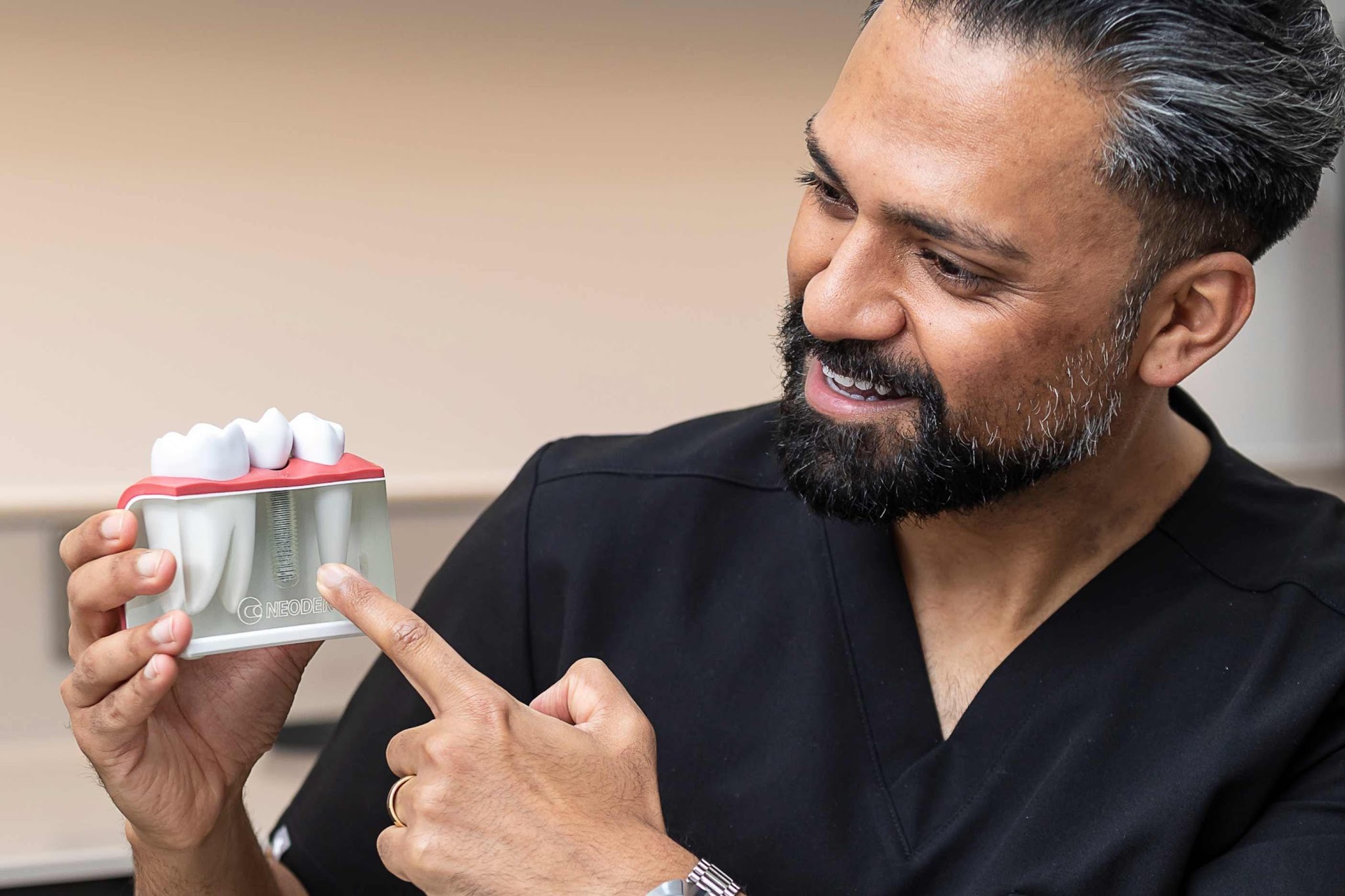 Dr Vishal Patel explaining dental implant treatment and tooth replacement options in Upminster