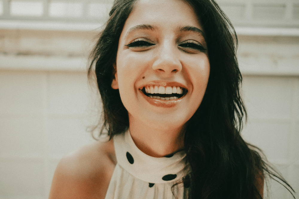 Woman smiling confidently after professional teeth whitening treatment in Upminster