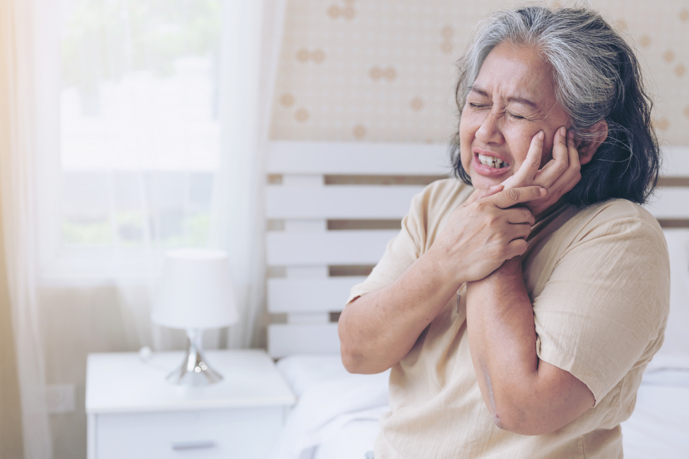 Woman experiencing severe toothache before seeking an emergency dentist in Upminster