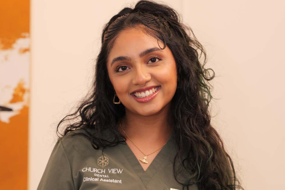 Friendly clinical assistant welcoming patients to Church View Dental in Upminster