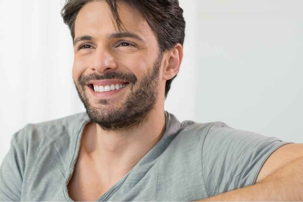 Man smiling after cosmetic dental treatment