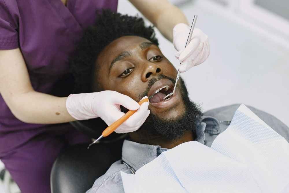 Patient having teeth examined by a dentist