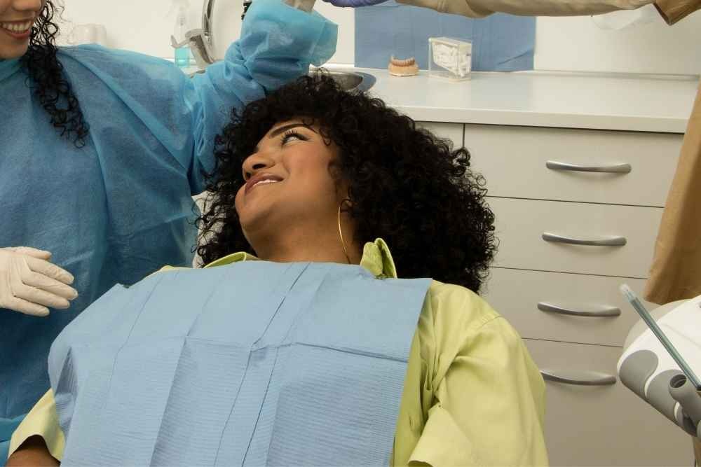 Patient smiling while receiving treatment from a dentist