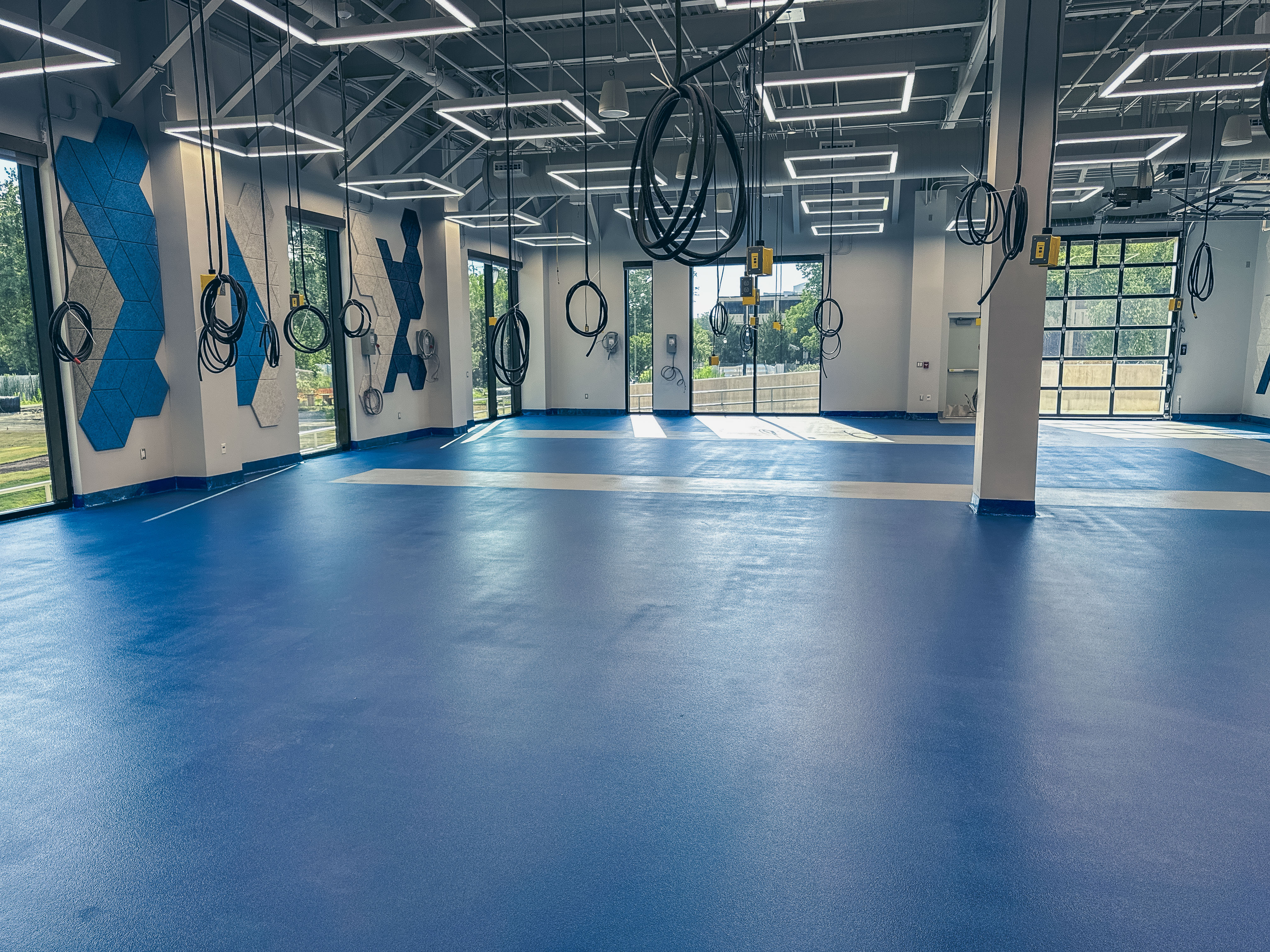 Completed blue epoxy flooring system inside MTSU Applied Engineering Building laboratory space, designed for durability and heavy student traffic.