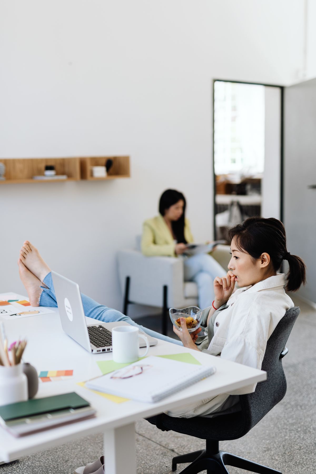 Two colleagues working in a shared workspace.