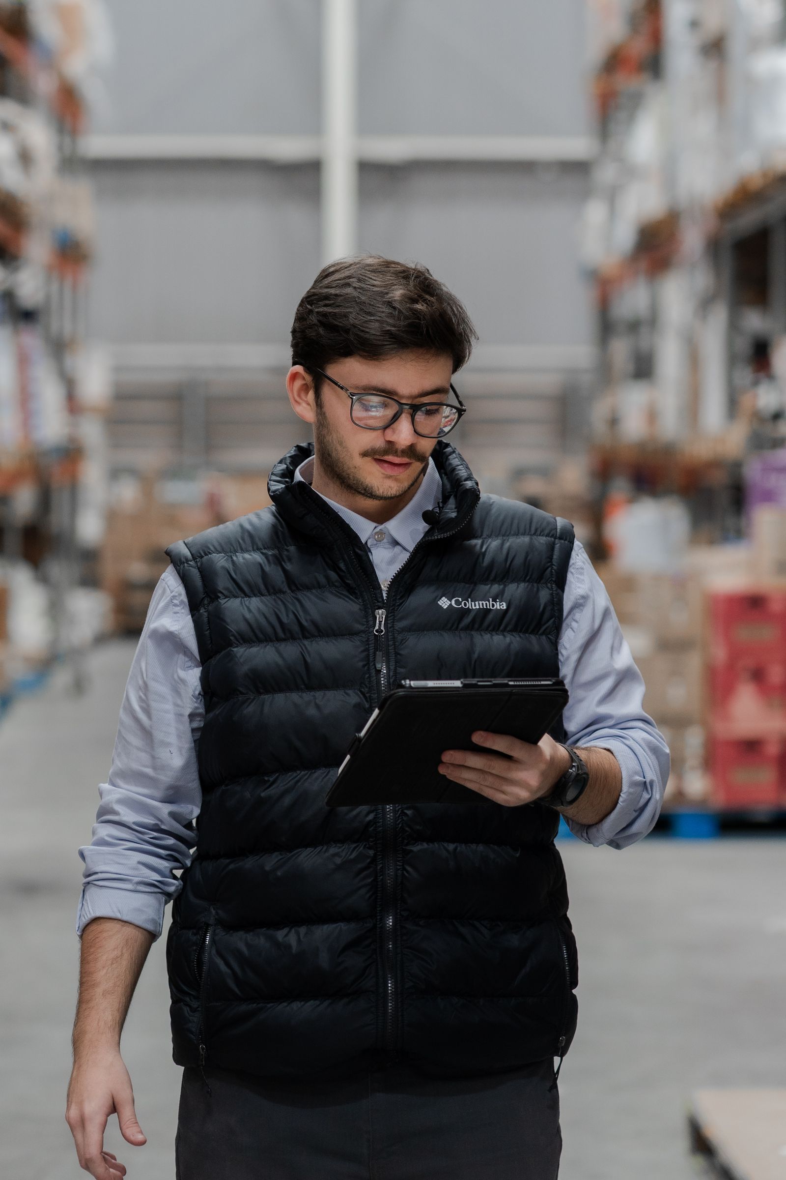 A warehouse team member working with a tablet