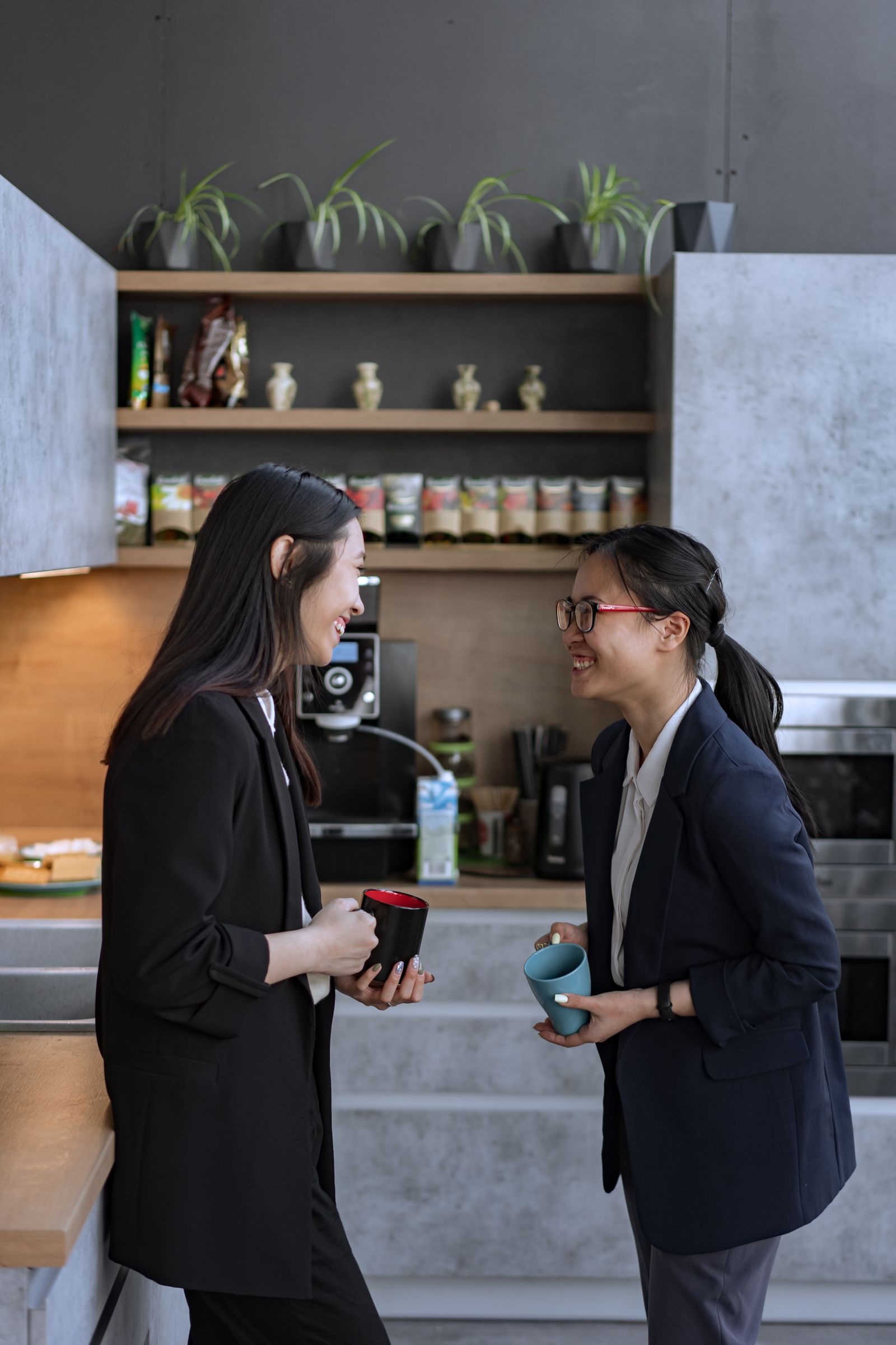 Colleagues talking in the office kitchen