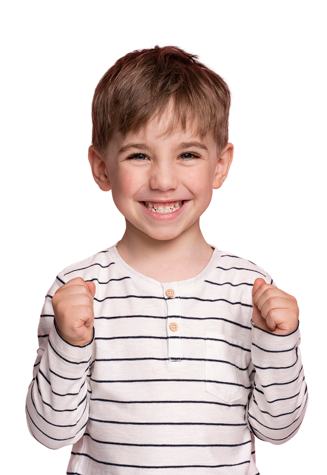 A young boy with a striped shirt and a smile on his face.