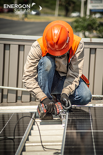 image of a technician installing solar panels