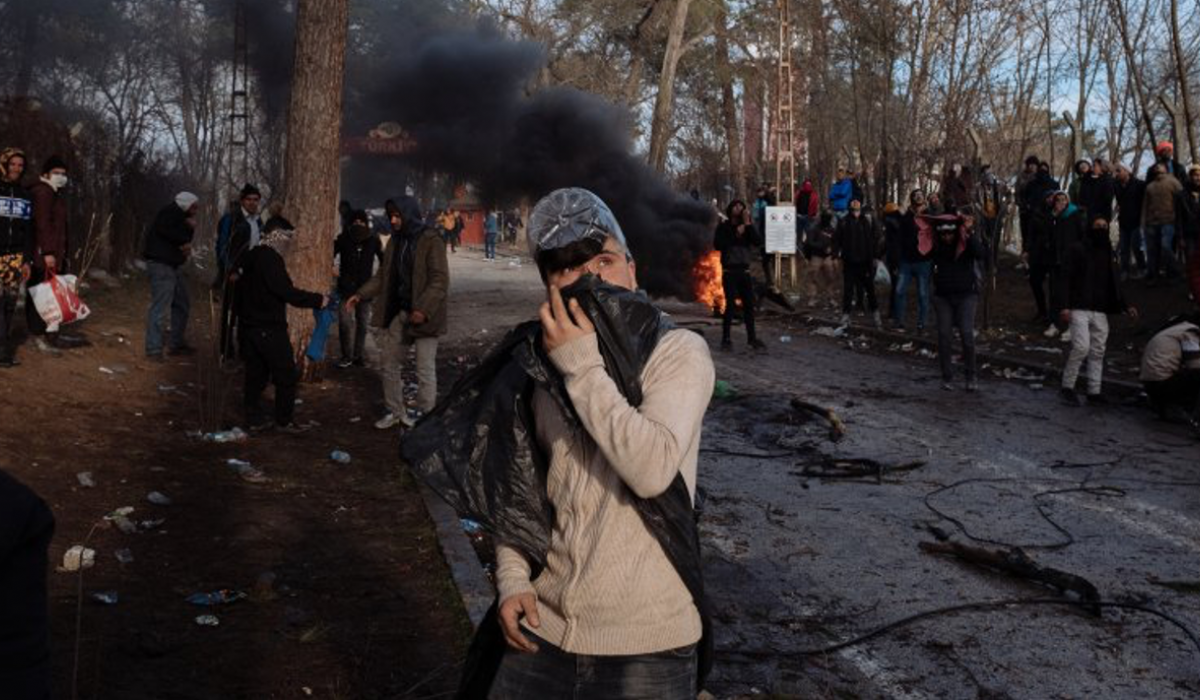 Protest scene with burning fires, smoke, and crowd in winter forest