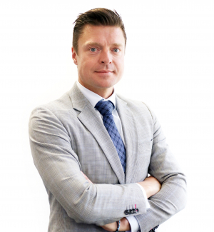 Professional businessman in gray suit and blue tie standing confidently