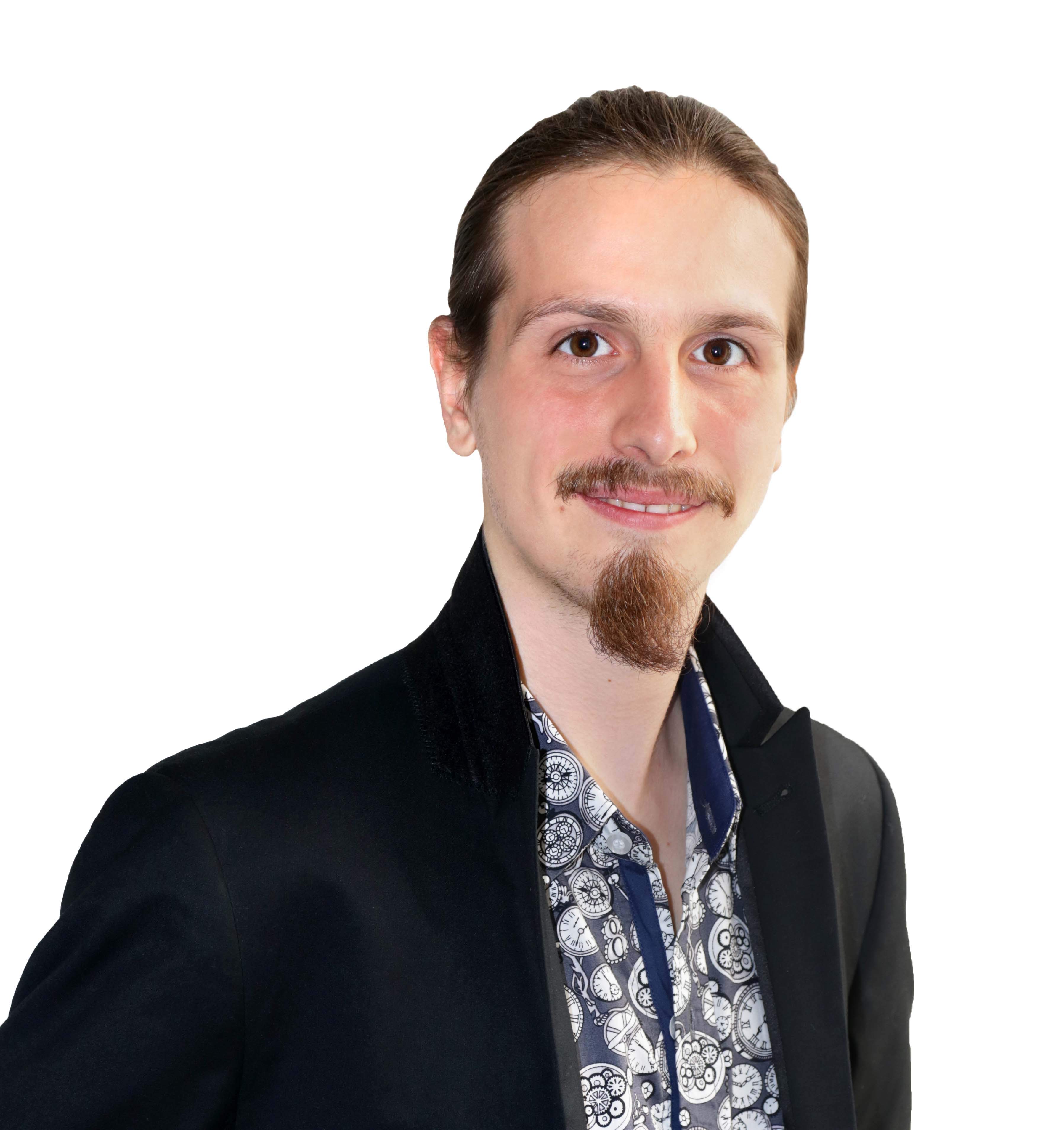 Man in black jacket and patterned shirt smiling at camera