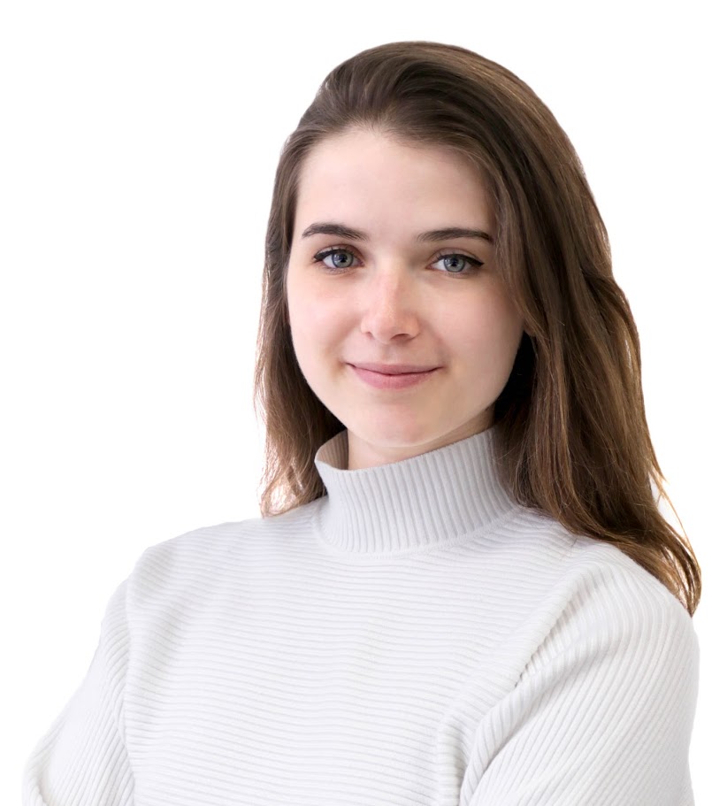 Woman in white sweater looking softly at camera with gentle smile