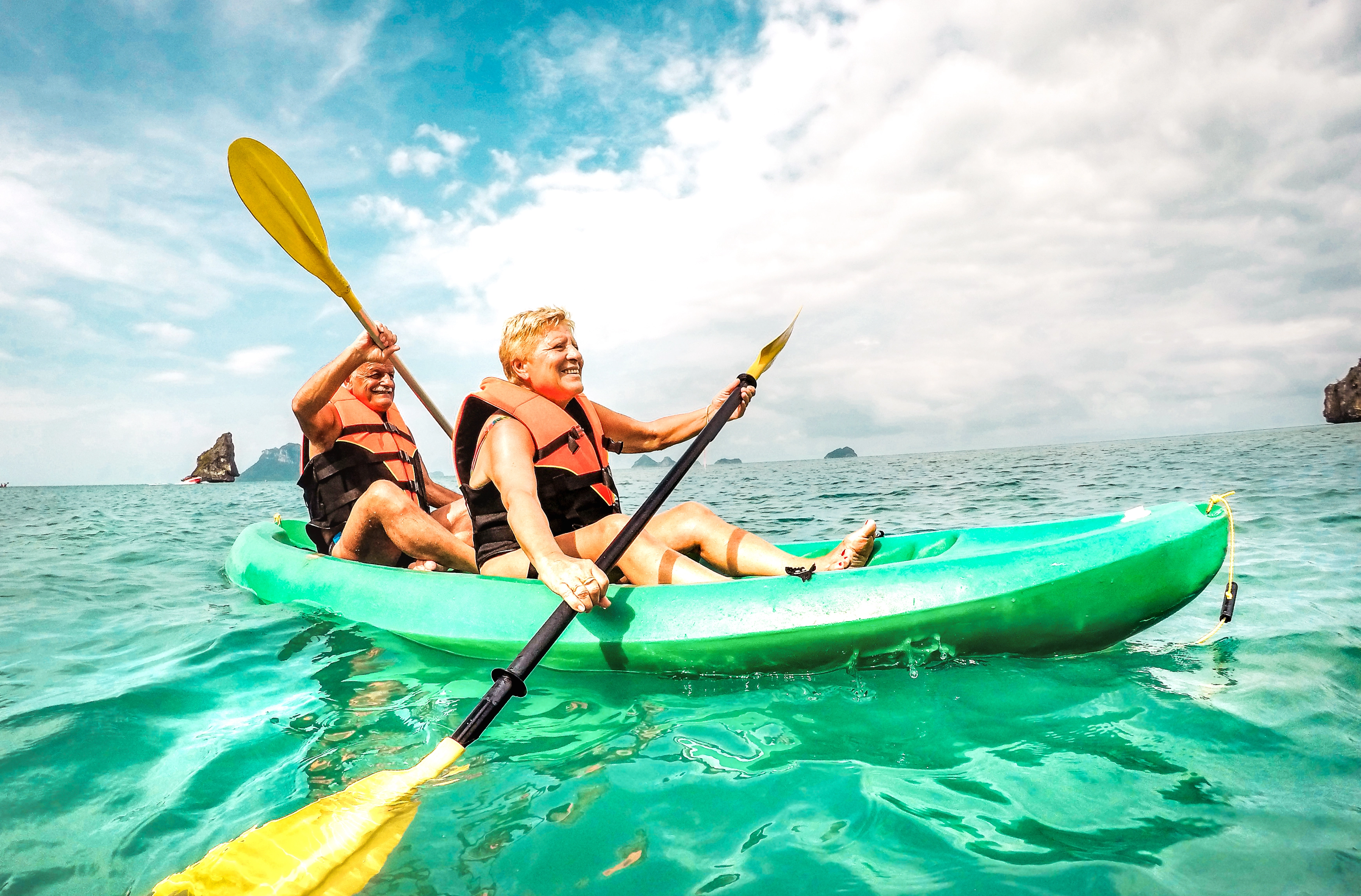 Mature couple paddling a kayak 