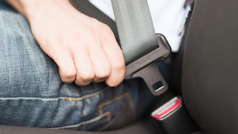 Conducteur ajustant sa ceinture de securite