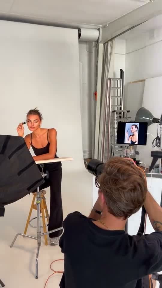 The photographer shooting the model at the white table