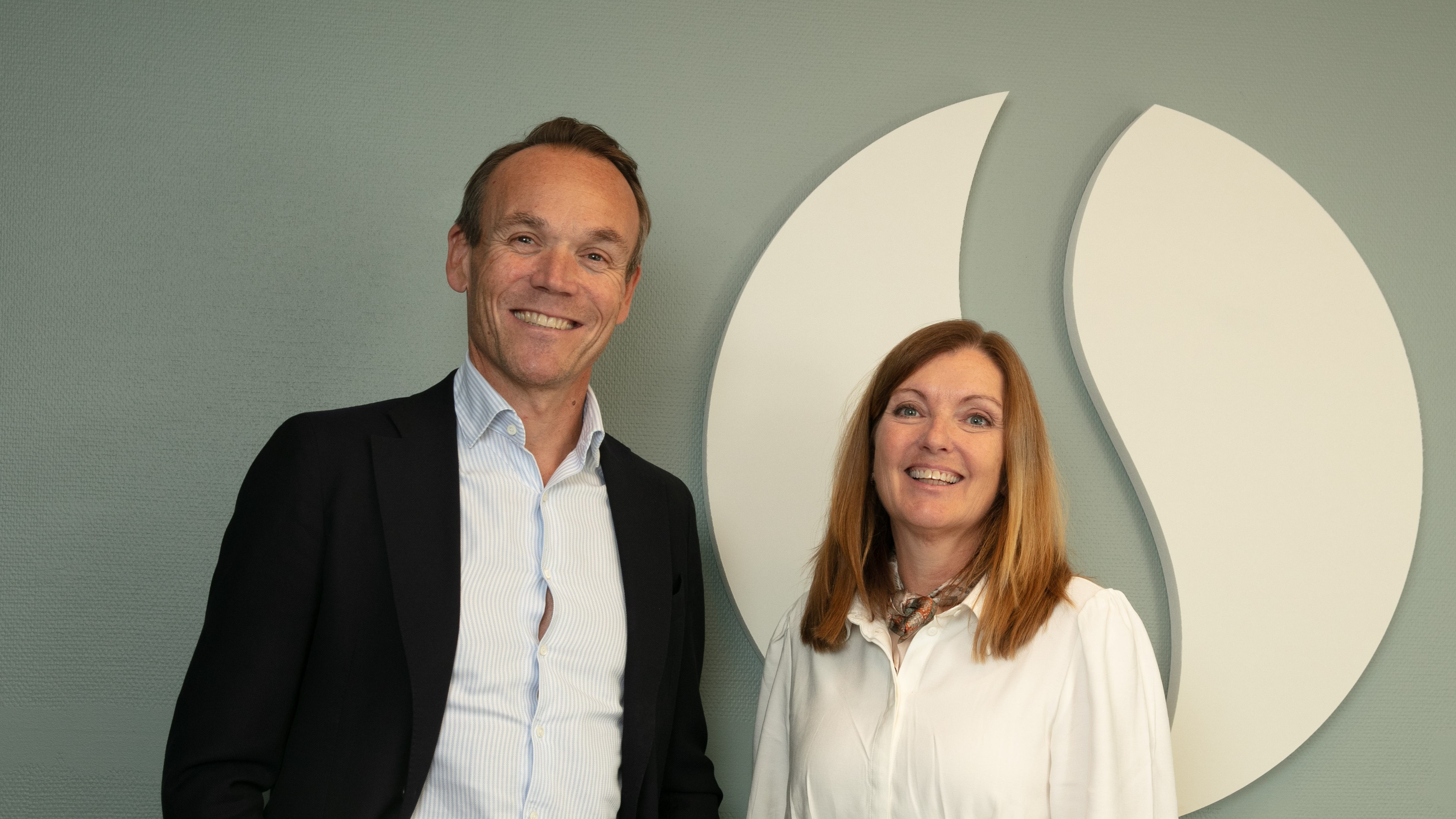 Arne Nypan og Kjersti Lyford foran Strateras logo