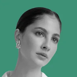 A woman with a ponytail and earrings.