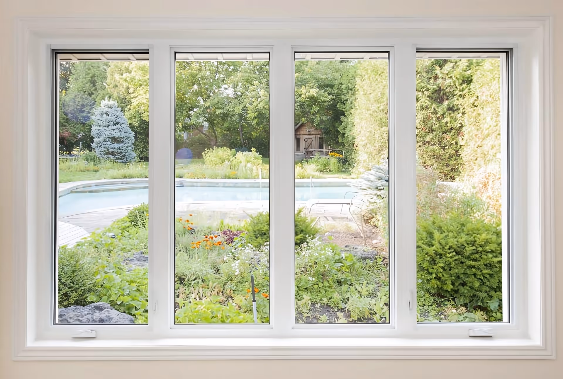 Tall four-pane window overlooking a lush garden with flowers, trees, a swimming pool, and outdoor furniture.