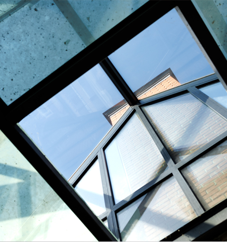 Elegant conservatory with glass roof and modern frames designed by trusted upvc doors and windows suppliers for homes