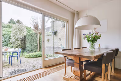 Elegant sliding patio doors open to a charming patio adorned with potted plants, perfect for UK outdoor living.