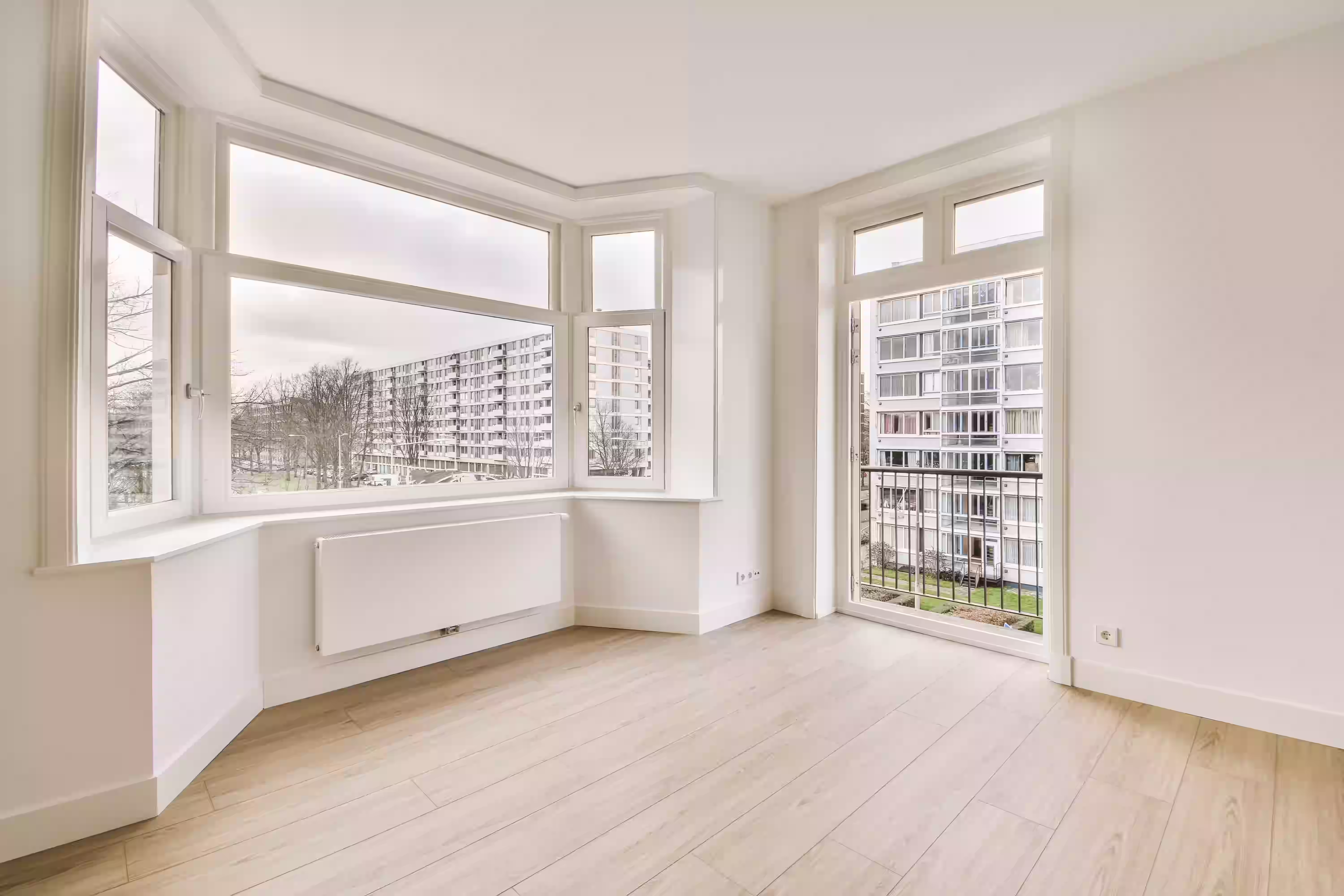 uPVC bay windows frame a picturesque view of a lush green field, enhancing natural light and outdoor connection.