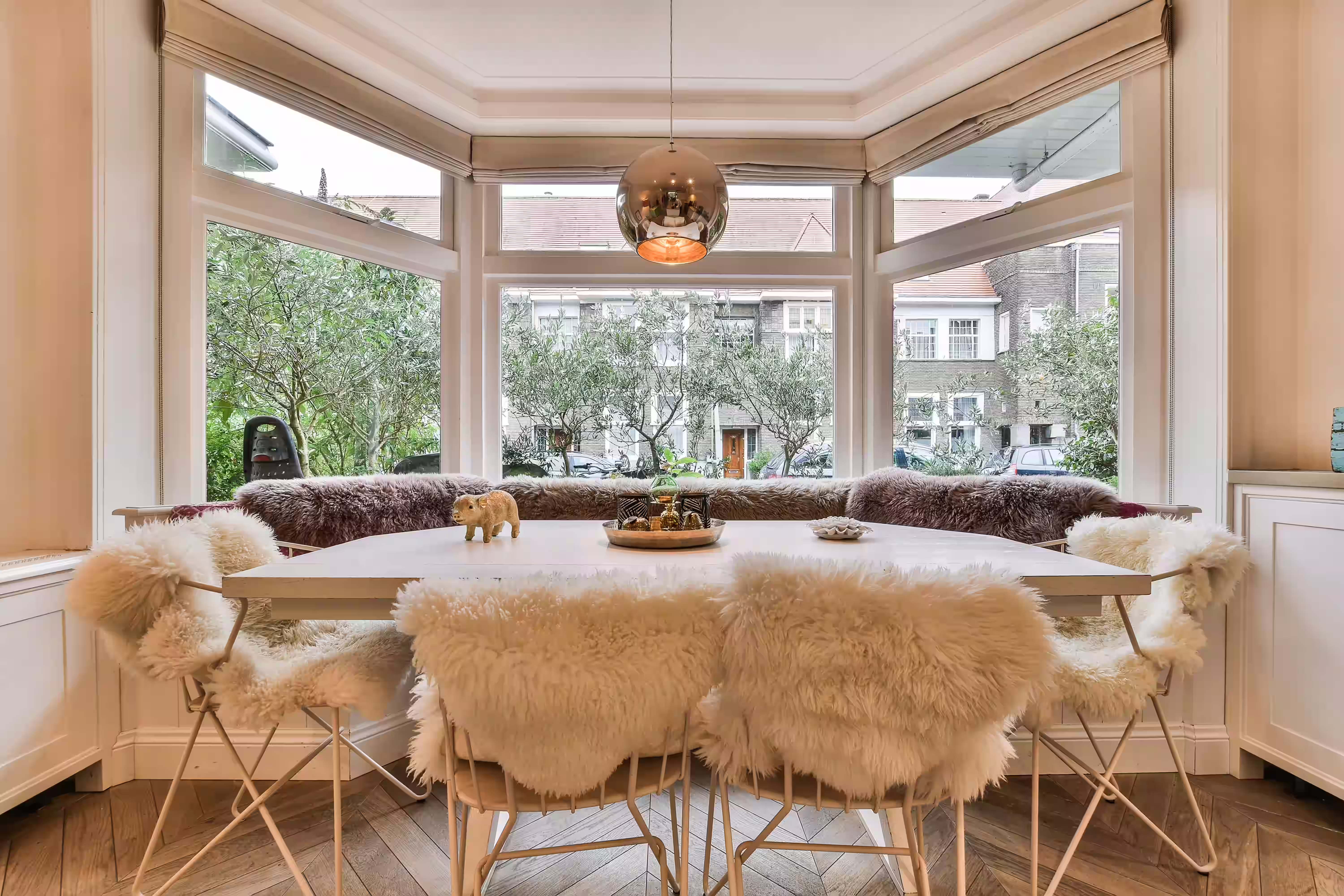 Elegant dining room featuring a table and chairs, illuminated by natural light from stylish uPVC bay windows.