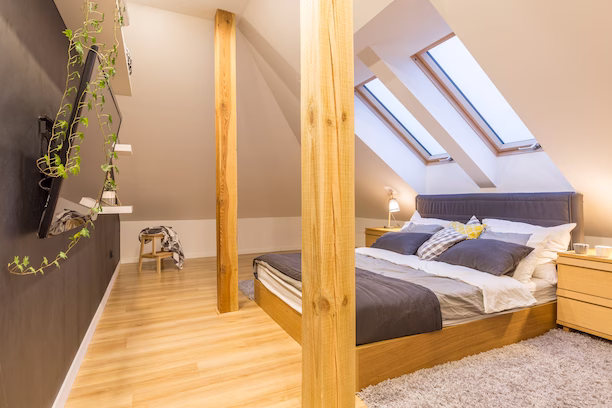 Bright bedroom featuring a bed beneath a skylight, showcasing elegant rooflights and roof lanterns for natural light.