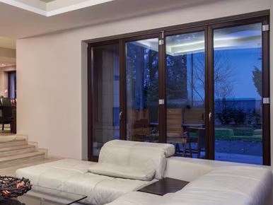 A house with a car parked outside, featuring stylish heritage aluminium doors for a modern touch in the UK.