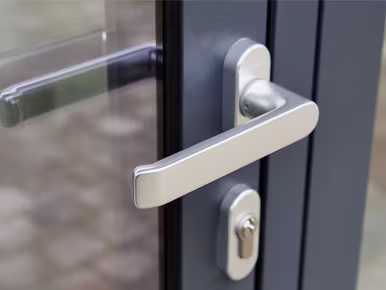Stylish aluminium door with a handle and window, exemplifying quality craftsmanship from leading aluminium door manufacturers.
