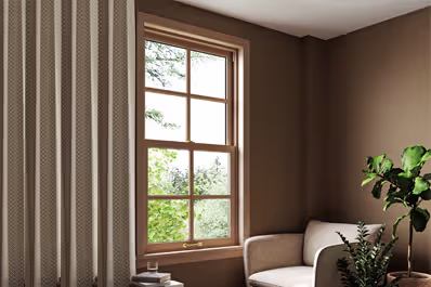 Modern white sliding sash window with a sleek frame and trim, enhancing contemporary architectural aesthetics.