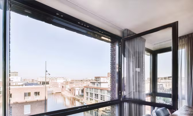 Modern sliding glass door with sleek metallic frame by trusted window and door suppliers, connecting indoor space to garden patio.